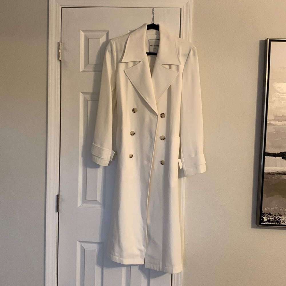 Cream/white double breasted women’s trench coat.